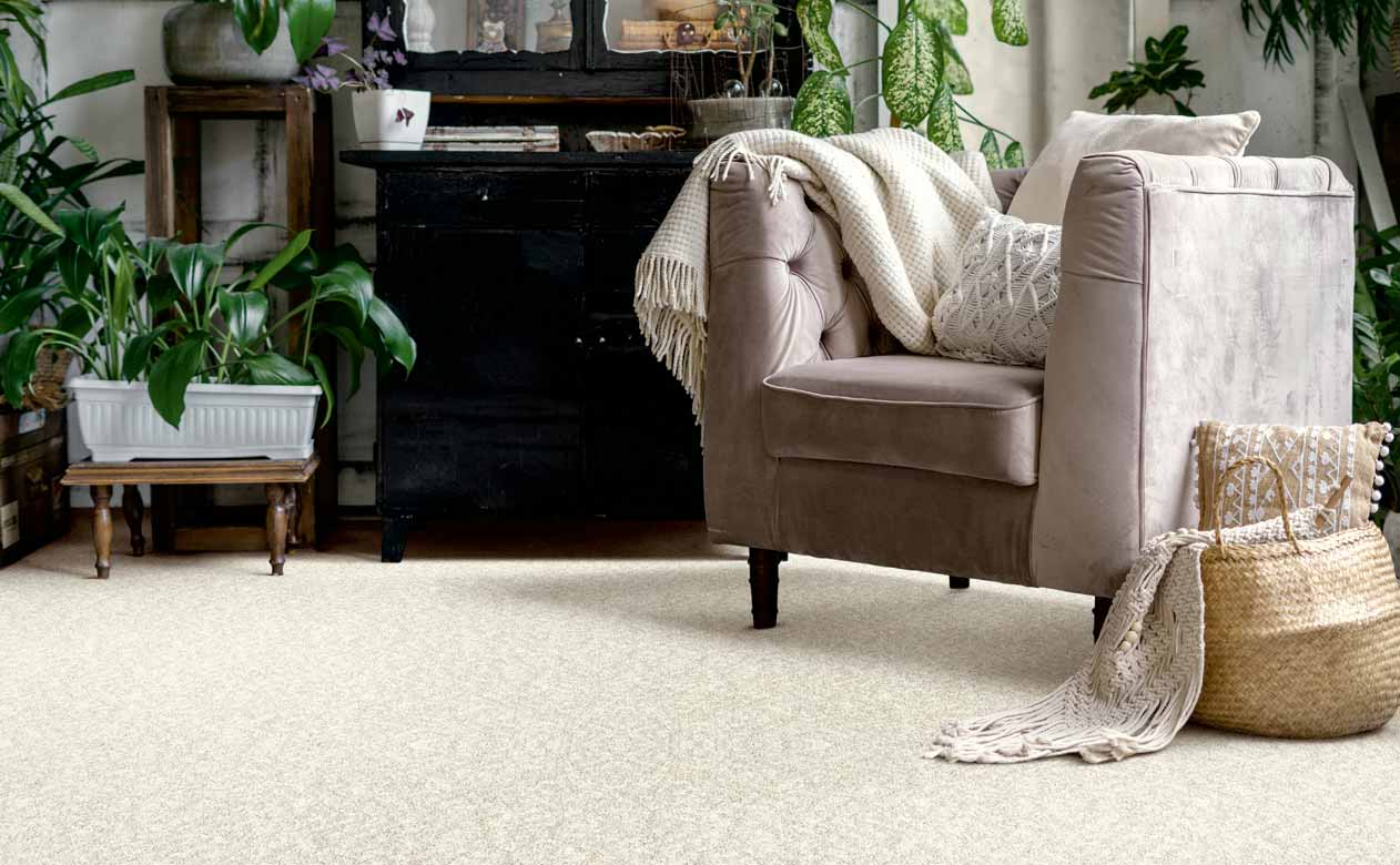 beige carpet in a living room with a velvet accent chair