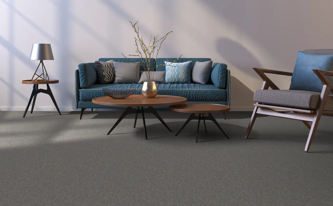 Living room with soft grey and cream furniture and carpet.