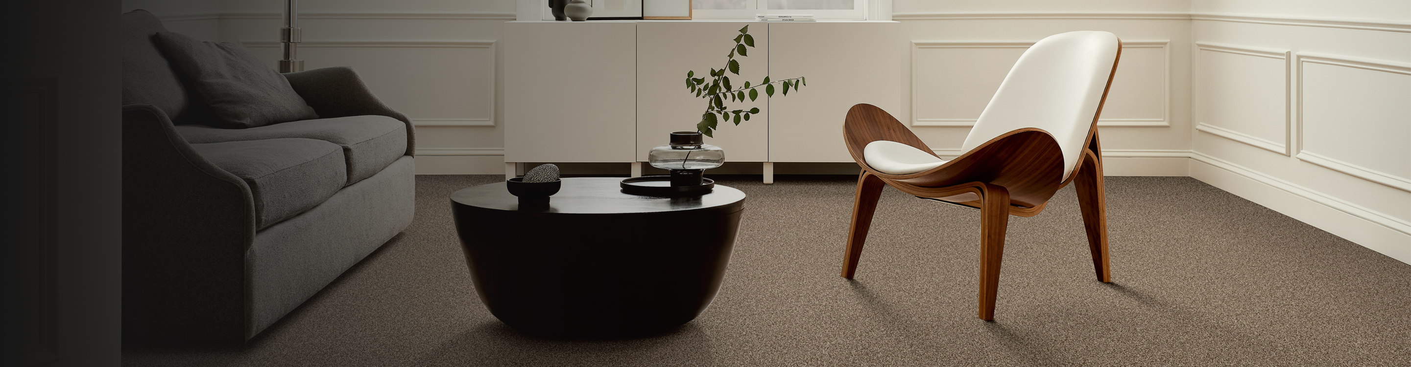 brown carpet in a sitting area with a wooden accent chair