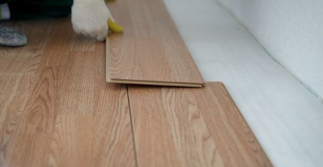 installer installing wood flooring planks